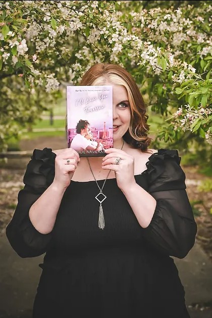 Author Julie Navickas poses with a copy of one of her novels
